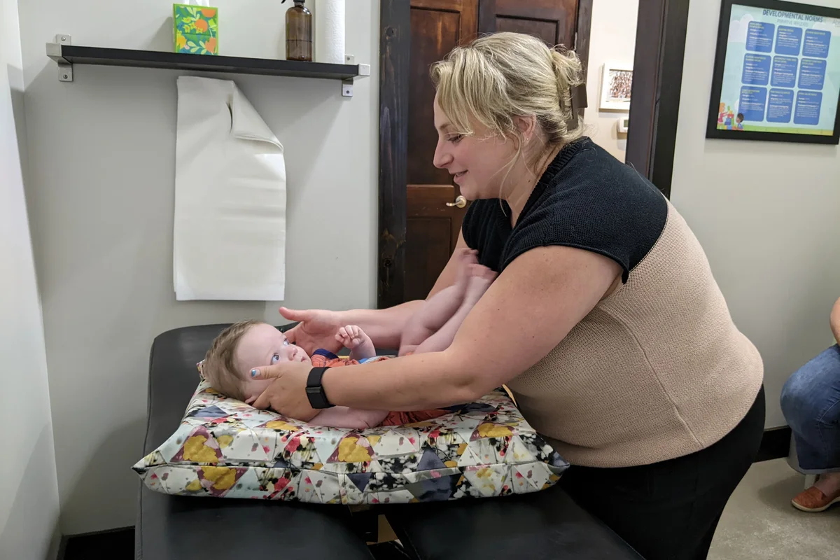 An infant on a pillow during hands-on cranial work.